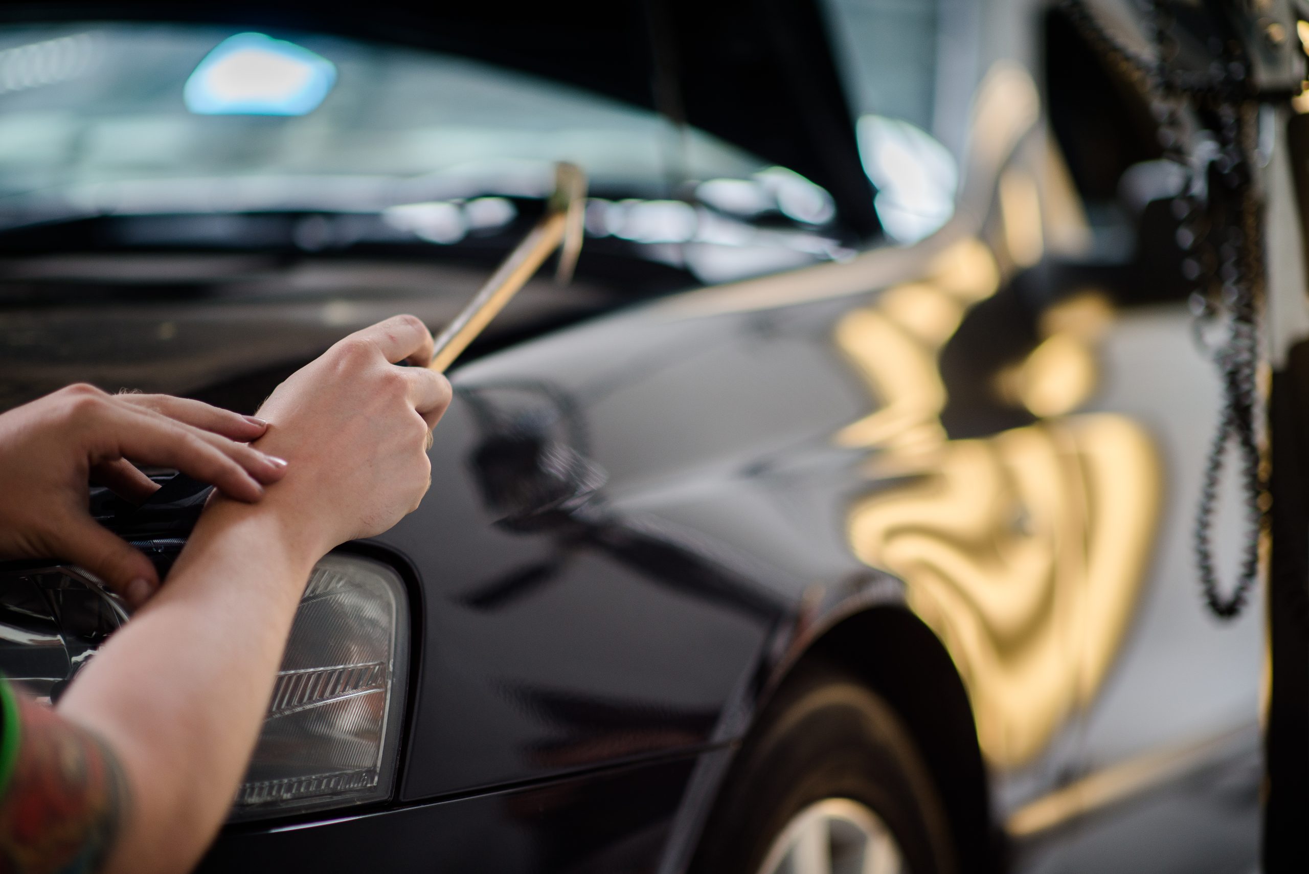 UHR technician using specialist tools to repair a vehicle panel
